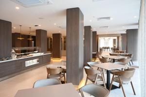 a restaurant with tables and chairs and a counter at Ramada by Wyndham Duzce in Duzce