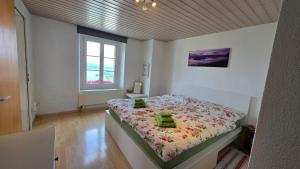 a bedroom with a large bed with flowers on it at Ferien auf dem Weingut in Ligerz
