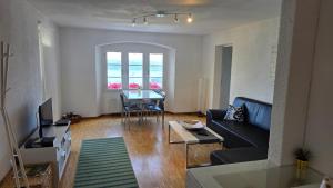 a living room with a couch and a table at Ferien auf dem Weingut in Ligerz