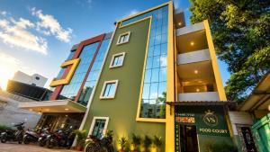 a building with motorcycles parked in front of it at M R Hotels in Visakhapatnam