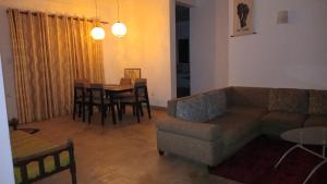 a living room with a couch and a table at D&D Holyday Homes in Kandy