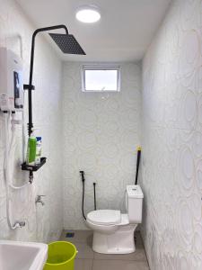 a bathroom with a toilet and a sink at Arkan Cottage in Kampong Tok Saboh