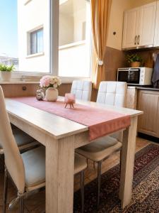 a kitchen with a wooden table and chairs at ApartmentDanny in Hisarya