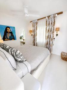 a white bedroom with a bed and a couch at My Island Home Vanuatu in Eton