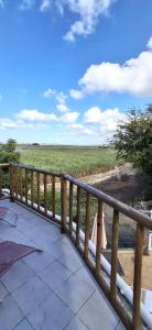 a wooden balcony with a view of a field at Bay Rose in Pointe d'Esny