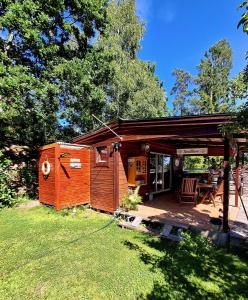 a small cabin with a porch and a patio at Tottes Resort in Kolmården