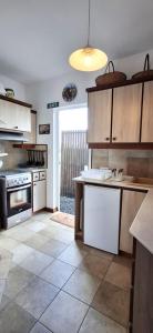 a kitchen with wooden cabinets and a stove top oven at Bay Rose in Pointe d'Esny