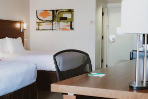 a hotel room with a desk and a bed and a table at Quality Inn Rouyn-Noranda in Rouyn-Noranda +114 photos