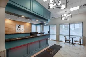 a lobby with a waiting area with a counter and chairs at Quality Inn & Suites in Niagara Falls