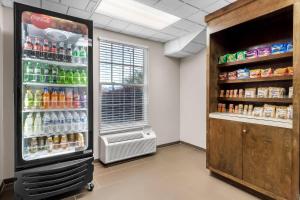a large soda refrigerator in a room with drinks at Comfort Suites Sumter near Shaw AFB in Sumter