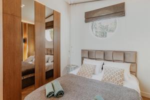a bedroom with a bed with two shoes on it at Lavyso perlai, 1-2 nameliai in lavysas