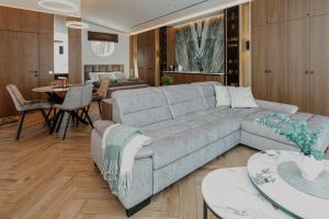 a living room with a couch and a dining room at Lavyso perlai, 1-2 nameliai in lavysas