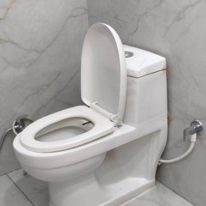 a white toilet with the lid up in a bathroom at Hotel Star Palace -Affordable Premium Rooms Near Taj mahal in Agra