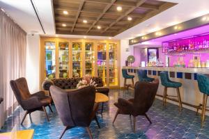 a bar in a restaurant with chairs and a bar counter at Faranda Collection Cali, a member of Radisson Individuals in Cali