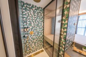 a bathroom with a shower with a glass door at Hotel Faranda Rias Altas, Ascend Hotel Collection in Oleiros