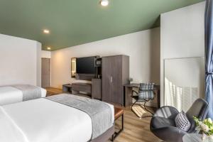 a hotel room with a bed and a flat screen tv at The Valor, an Ascend Collection Hotel in Parowan