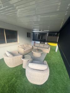 a living room with wicker chairs and a table at Surfers 641 in Gold Coast