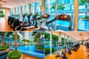 a gym with a swimming pool and exercise bikes at vortex Suites KLCC KL in Kuala Lumpur