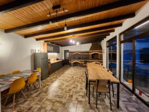 a kitchen and dining room with a wooden table and chairs at Impressive Târgu Ocna in Târgu Ocna