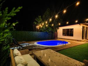 a backyard with a swimming pool at night at Impressive Târgu Ocna in Târgu Ocna