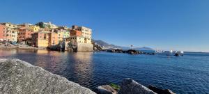 a large body of water with buildings and houses at Genova Porto Antico Boutique Rooms in Genoa