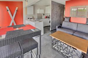 a kitchen and living room with a couch and a table at LE DONJON Villa BDSM Port Nature VILLAGE Cap d'Agde naturiste in Cap d'Agde