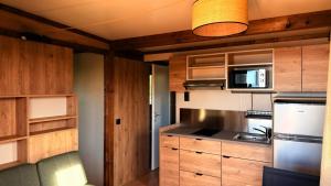 a kitchen with wooden cabinets and a stove top oven at Auberge Ferayola in Galeria