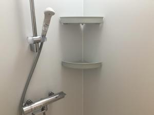 a close up of a shower in a bathroom at cocomio in Bungoono +3 photos