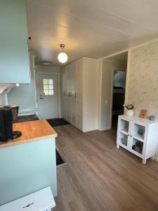 a kitchen with white cabinets and a counter top at Idyllic cottage with lake view with 11 beds in Ludvika