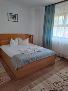 a bedroom with a large bed with white pillows at Pension Casa Maria in Sovata