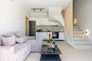 a living room with a couch and a table at Aurea Ionian Villas in Apolpaina