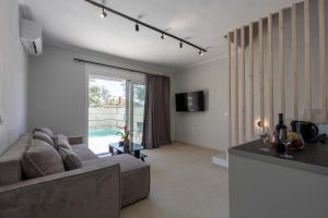 a living room with a couch and a table at Aurea Ionian Villas in Apolpaina