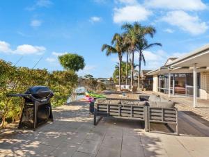a backyard with a bbq and a grill at Smada Stay - 4BR, Waterfront, Perfect Entertainer in Port Lincoln