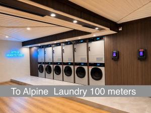 a row of washing machines in a laundry room at Apartment Olympia Matterhorn in Zermatt