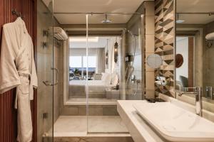 a bathroom with a shower and a sink at Sunrise Remal Beach Resort in Sharm El Sheikh