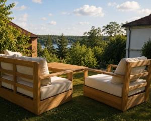 two wooden chairs sitting on top of a yard at HAUS 1926 Łagów Boutique Villa in Łagów
