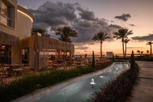 a resort with a swimming pool with tables and chairs at Sunrise Remal Beach Resort in Sharm El Sheikh