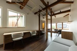 a room with a bar with chairs and tables at 鈴木旅館 in Joetsu