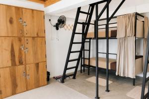 a bunk bed room with bunk beds and a ladder at Cloud Trails Hostel Ella in Ella