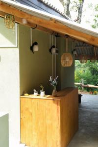 a wooden counter with potted plants on top of it at Cloud Trails Hostel Ella in Ella