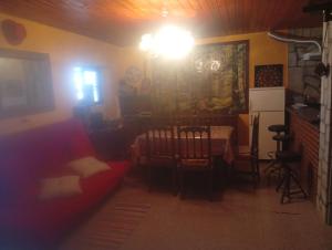 a living room with a red couch and a table at Elena's bar loft in Poio