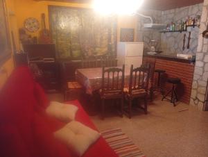 a living room with a red couch and a table at Elena's bar loft in Poio
