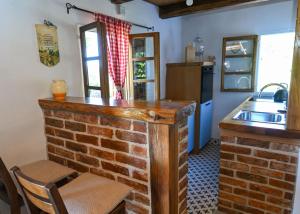 a kitchen with a brick wall and a sink at Kuća za odmor Josipa in Klanjec +57 photos