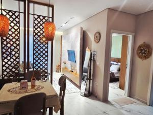 a living room with a table and a bedroom at 60 seconds walk to the Beach in Golem +21 photos