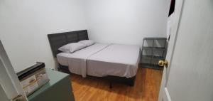 a bedroom with a bed with two pillows on it at E3 Hostings in Hamilton