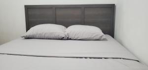 two pillows sitting on top of a bed at E3 Hostings in Hamilton