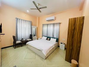 a bedroom with a bed and a ceiling fan at Vedsa haveli new in Udaipur
