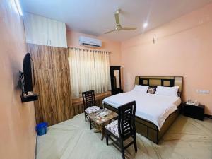 a bedroom with a bed and a table and chairs at Vedsa haveli new in Udaipur +2 photos