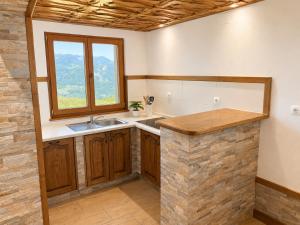 a kitchen with a sink and a window at Mohoričeva domačija in Idrija