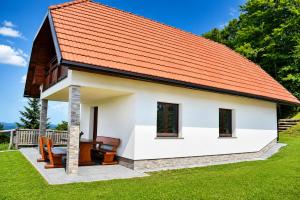 a small house with an orange roof at Mohoričeva domačija in Idrija